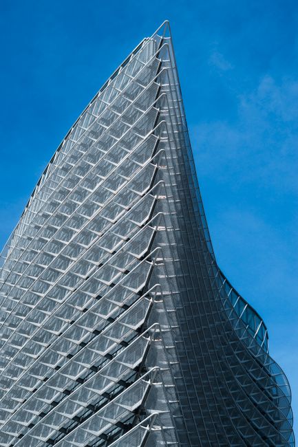 Stunning low-angle view of Zaragoza's iconic Torre del Agua against a clear blue sky.