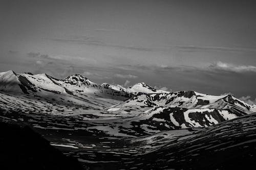 Grayscale Photo of Snow Covered Mountain