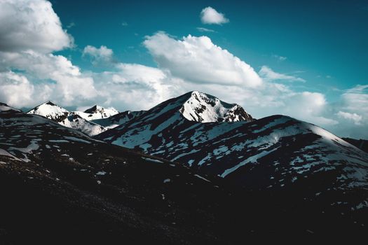 Breathtaking view of snow-capped mountains under a vibrant sky in Chilas, ideal for nature photography.