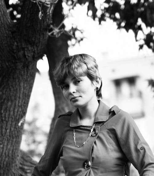 A Grayscale Photo of a Short Haired Woman in Gray Long Sleeves