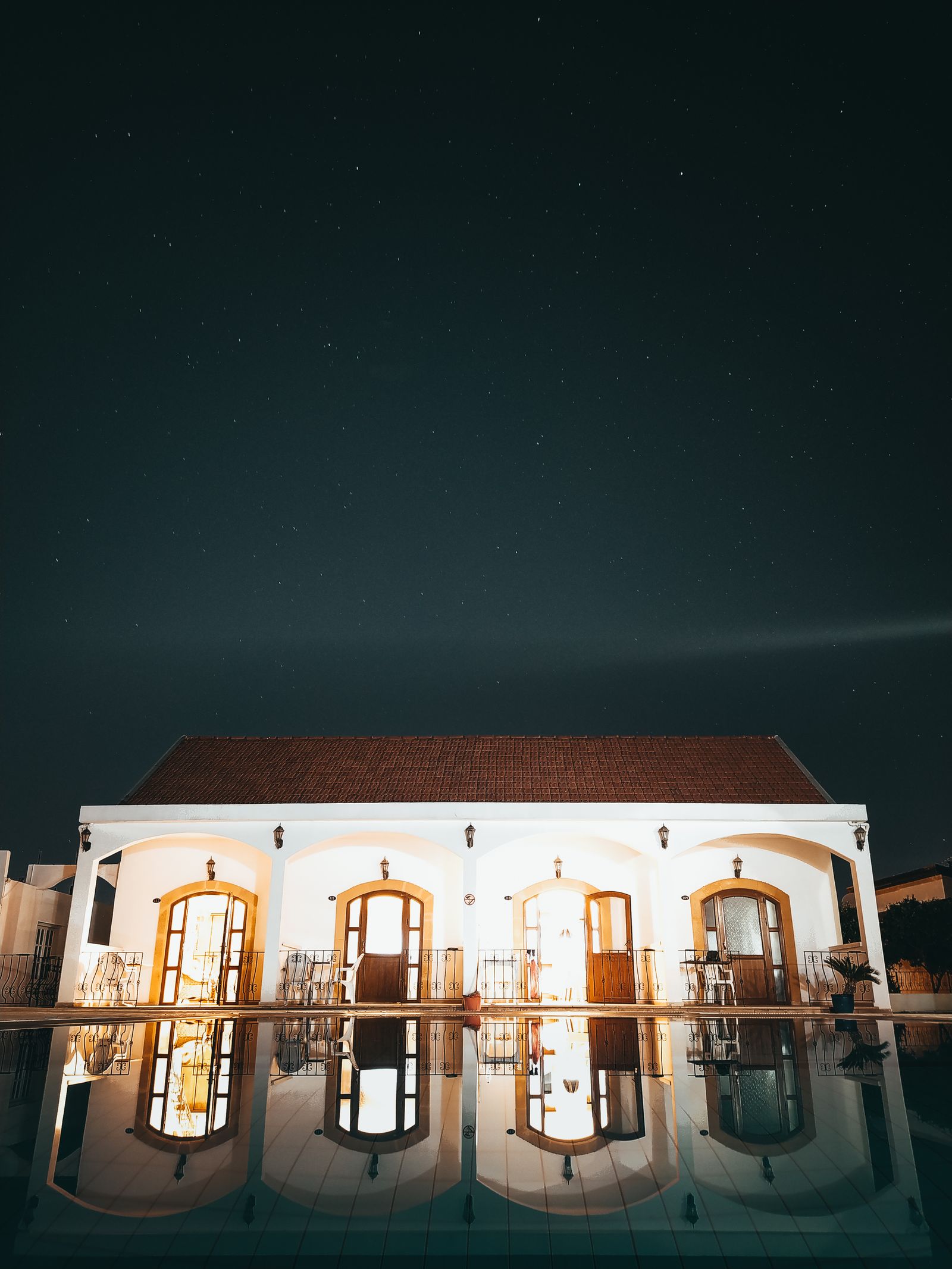 Evening pool terrace with underwater lighting at the Foxcroft Courtyard House