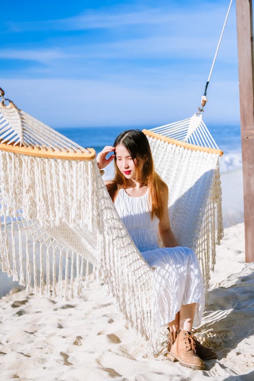 Free Woman in White Dress Sitting on a Hammock Stock Photo