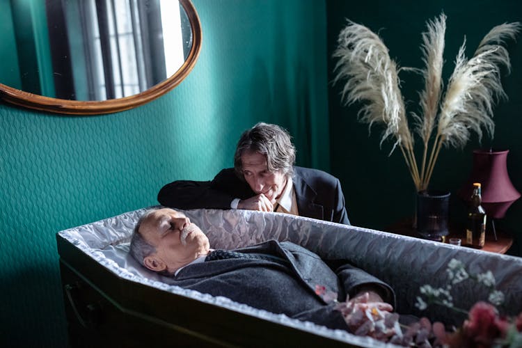 Man Looking At Dead Body In Coffin