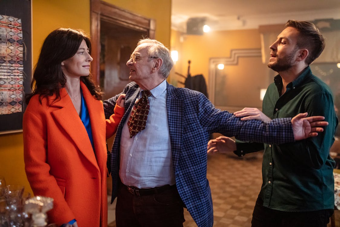 young gentleman rushing to woman in red over coat.