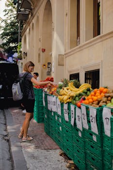 Woman shopping for fruits and vegetables at an outdoor market in Istanbul.