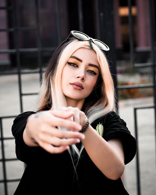 Free Portrait of a Young Woman Reaching Her Arms Towards the Camera  Stock Photo