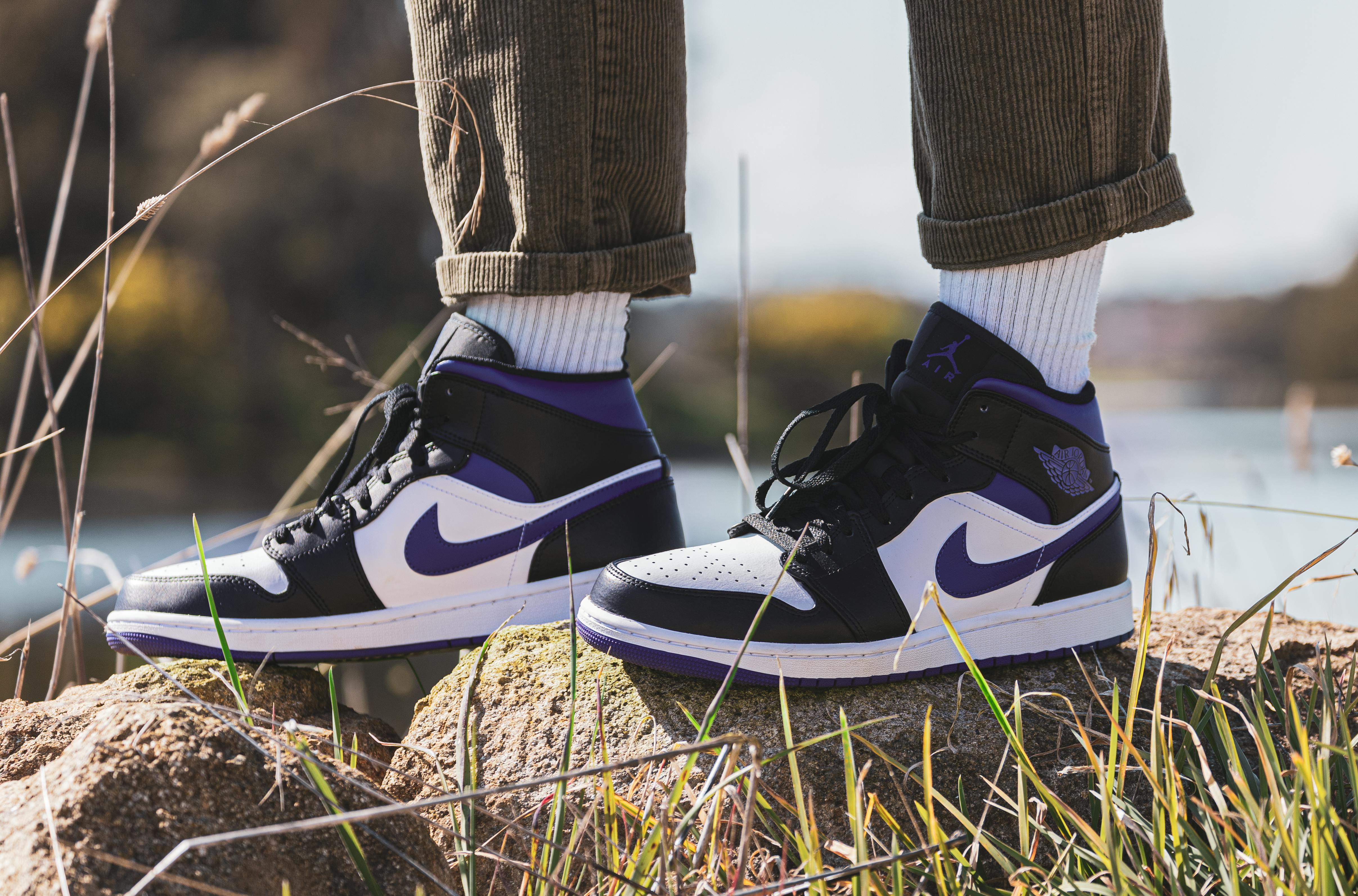 Person Wearing White And Blue Air Jordan 1's · Free Stock Photo