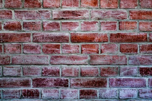 Free typical red brick wall with scratches  Stock Photo