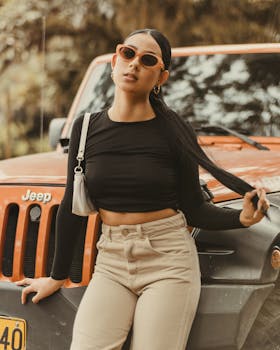 Young woman posing in front of jeep outdoors in Pitalito, Colombia.