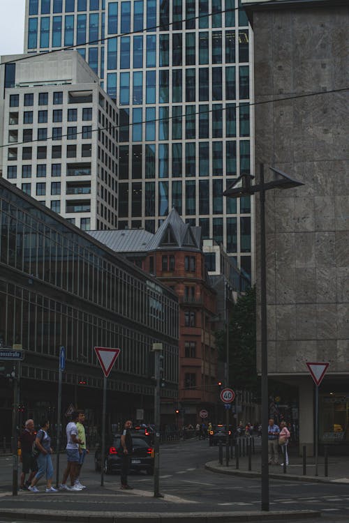 People Walking on the Street near Concrete Buildings