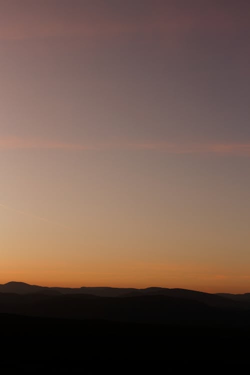 A Silhouette of Mountains during the Golden Hour