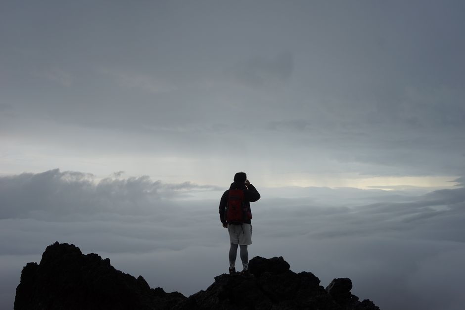A climber reaching the peak: symbolizing the journey to debt freedom - how to pay off large student loan debt A climber reaching the peak: symbolizing the journey to debt freedom - how to pay off large student loan debt