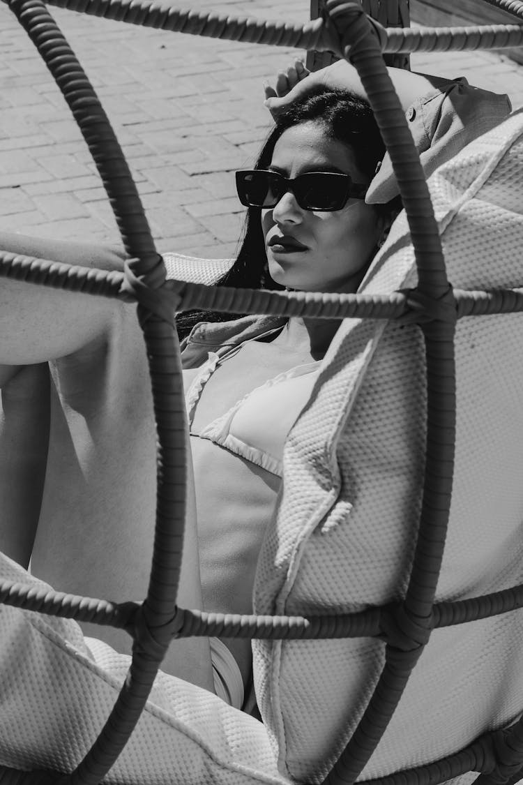 Woman In Bikini Lying In Chair On Beach