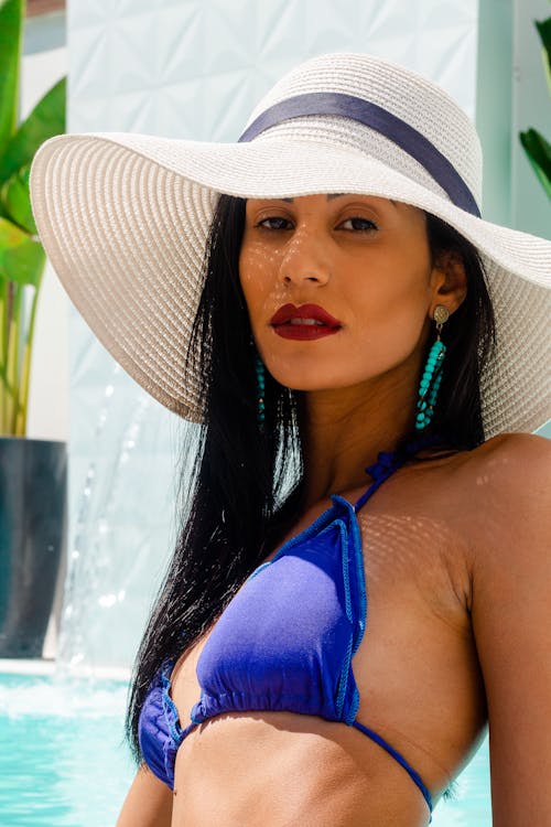 Woman in Blue Bikini Wearing White Sun Hat