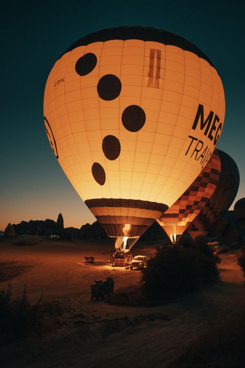 Free Hot air balloons illuminated at twilight, creating a picturesque landscape. Stock Photo