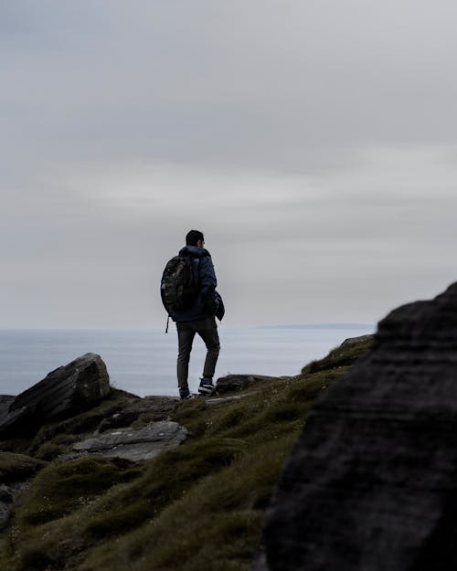 A Man Hiking a Mountain