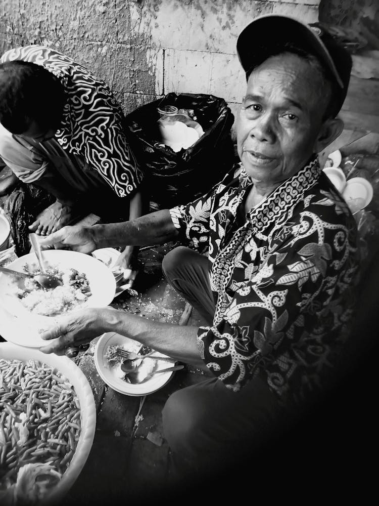 Eldery Man Sitting And Eating Food 