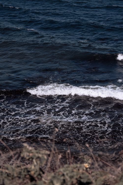 Free Captivating scene of waves crashing on a rocky coastline beach, reflecting nature's power and tranquility. Stock Photo