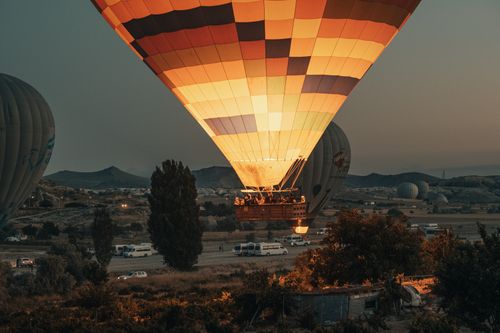 Free Hot air balloon rides over Cappadocia's landscape at sunset, showcasing adventure and beauty. Stock Photo