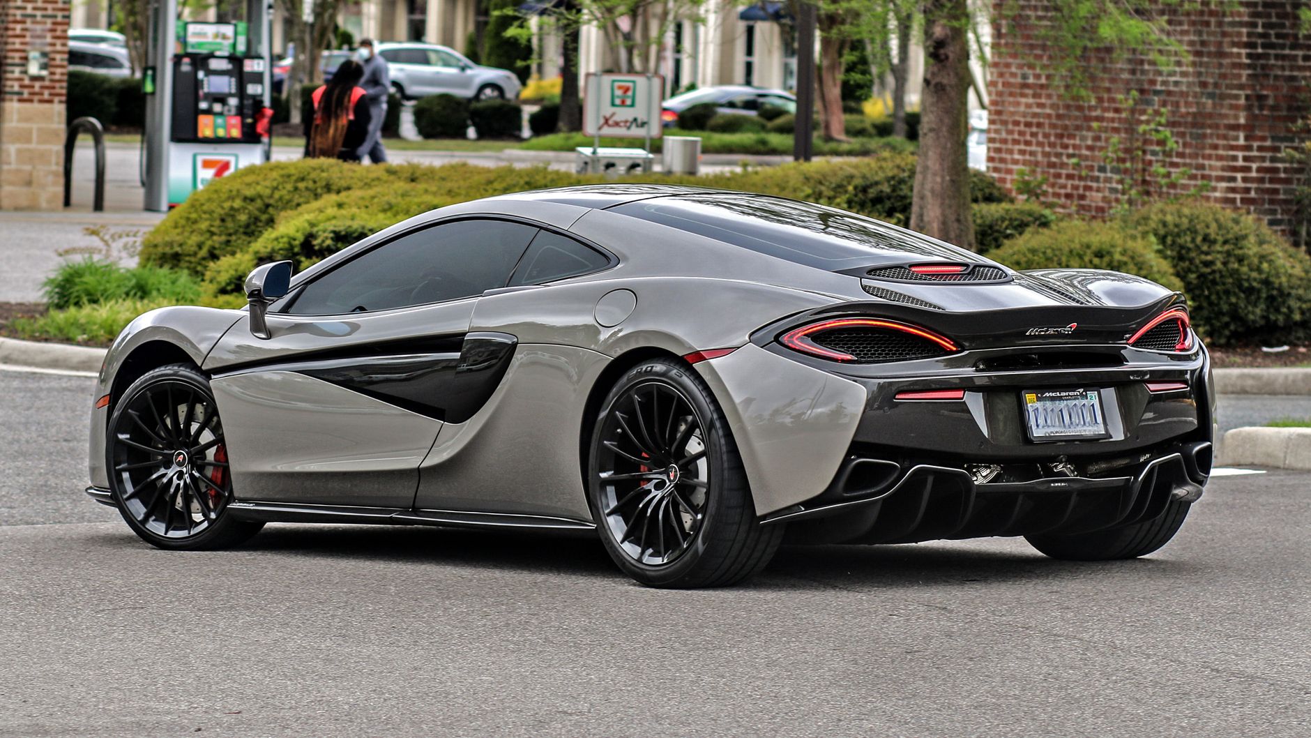 A stunning silver McLaren 570S supercar parked in an urban setting. Perfect for luxury car enthusiasts.