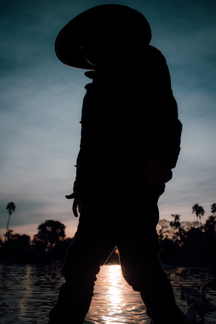 Silhouette Of Person Wearing A Hat