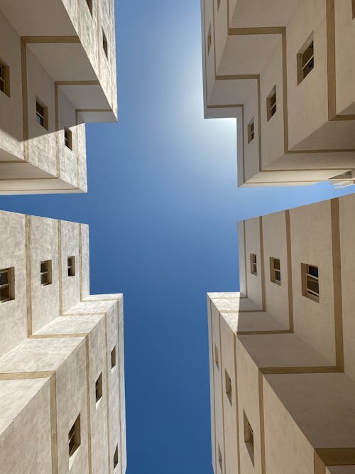 Kostenloses Stock Foto zu aufnahme von unten, betongebäude, blauen himmel