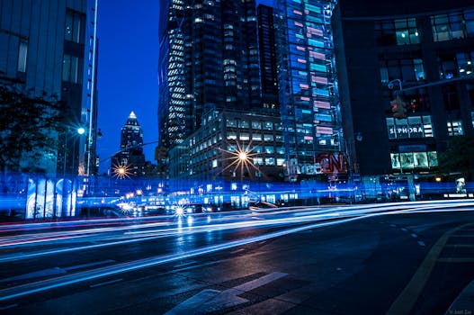 Vibrant cityscape featuring long exposure light trails and iconic skyline at night.