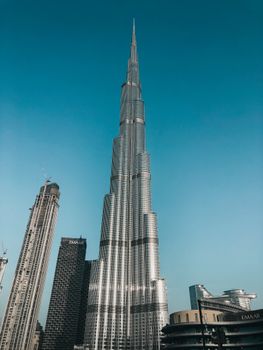 Stunning view of Burj Khalifa dominating Dubai's skyline against a clear blue sky.