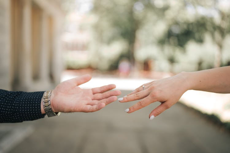 Close-up Of Bride And Groom Touching Hands