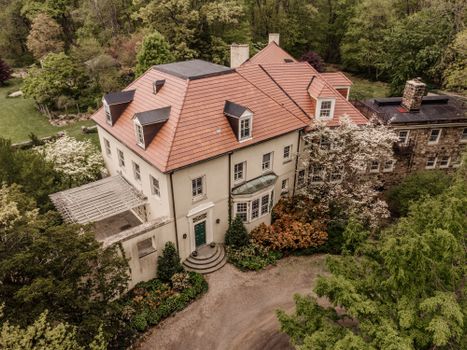 Aerial view of a stately mansion surrounded by lush greenery in Bernardsville, NJ.