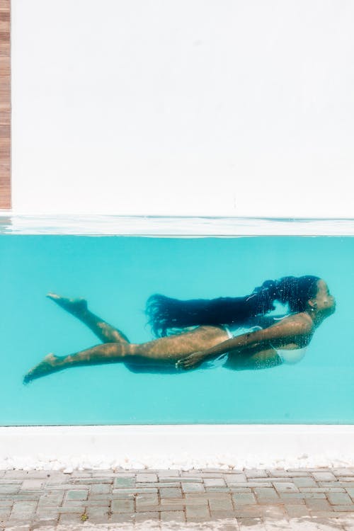 Woman in White Bikini Swimming Underwater