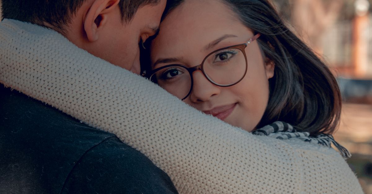 Hugging Sweater Woman in White Knitted Sweater Hugging a Man in Black Shirt · Free ...