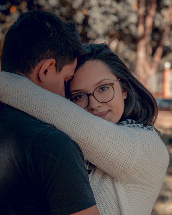 Hugging Sweater Woman in White Knitted Sweater Hugging a Man in Black Shirt · Free ...