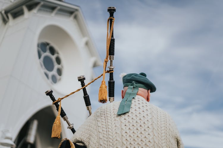 A Back View Of A Man With Bagpipes