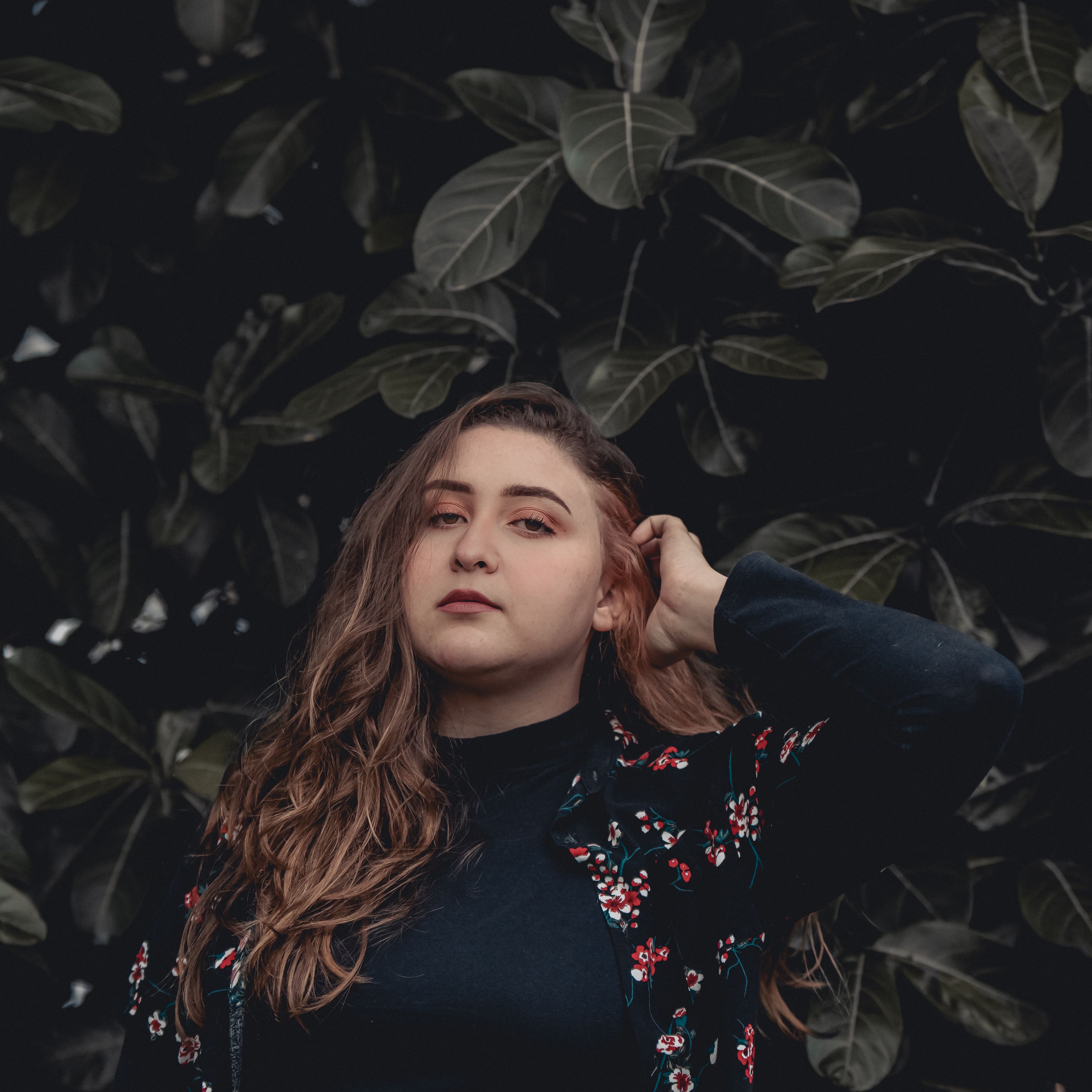 A Portrait of a Woman Wearing a Floral Top · Free Stock Photo