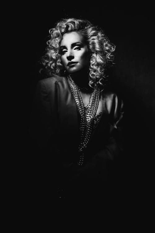Portrait of Woman with Curly Hair in Shadow in Black and White 