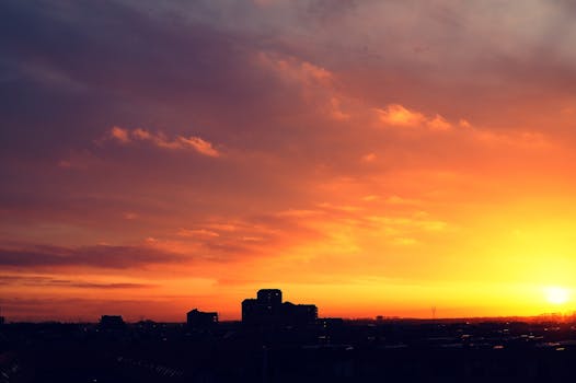Capture of a breathtaking sunset with vibrant skies and city silhouettes, perfect for urban landscape themes.