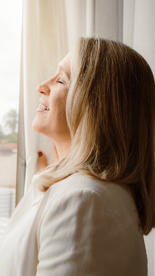 Smiling Woman by a Window