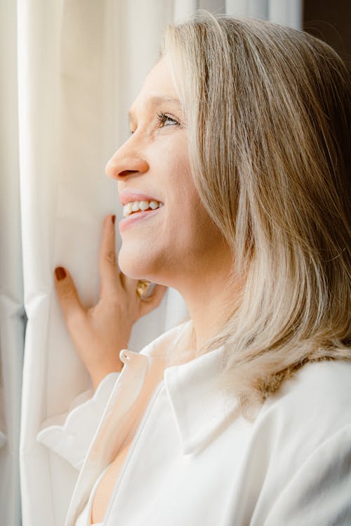 Smiling Woman Looking Through a Window