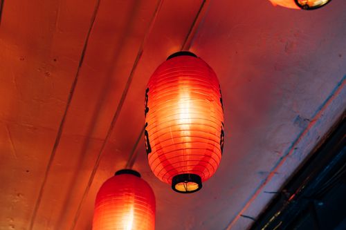 Free Close-up shot of red paper lanterns illuminating an indoor space. Stock Photo