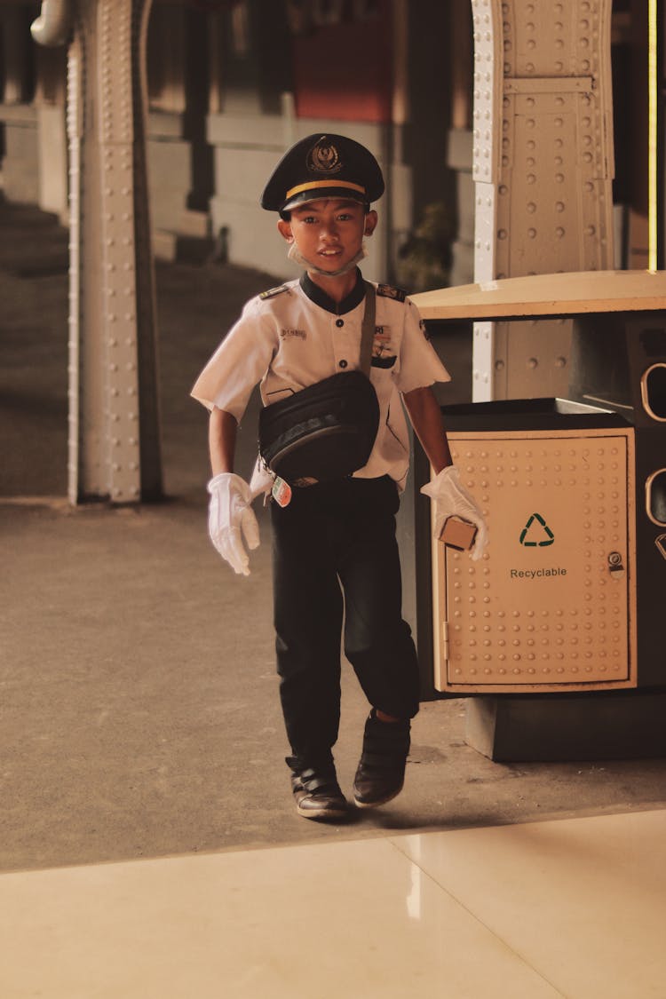 A Kid Dressed Up As A Conductor