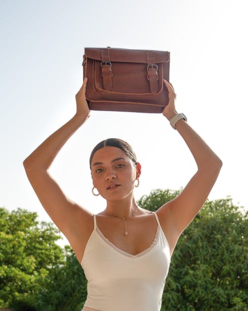 Woman Holding Bag over Head