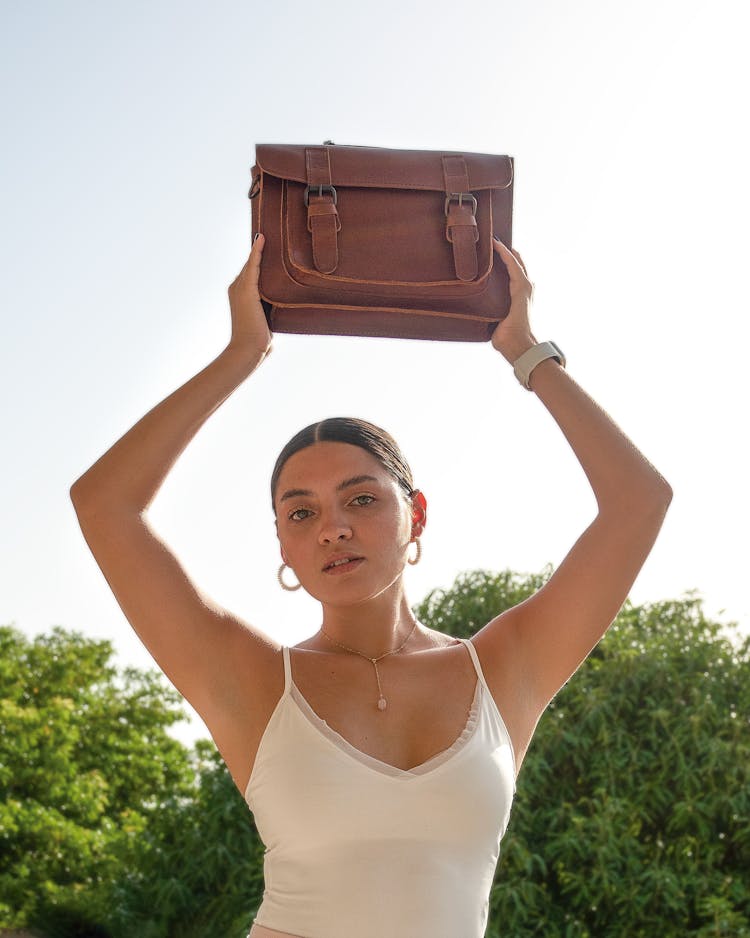 Woman Holding Bag Over Head