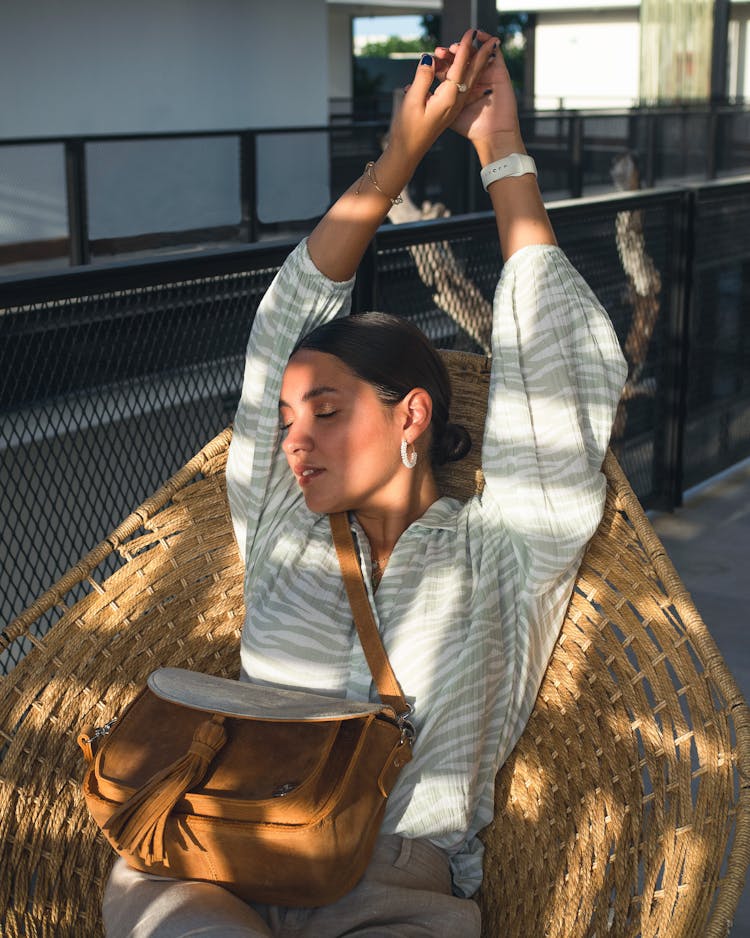 Woman Sitting In Straw Chair