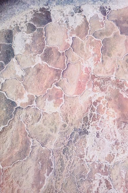 Aerial image capturing the intricate salt crust formations in a desert landscape.