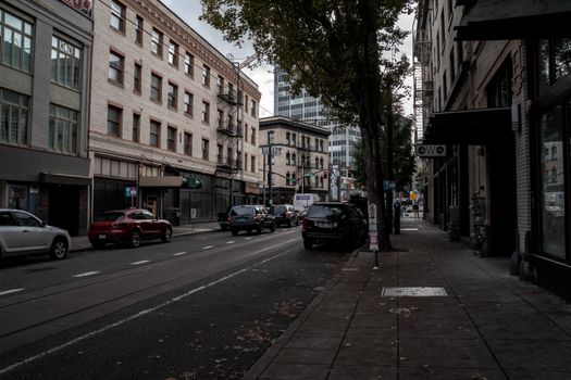 A bustling city street in Portland, Oregon, featuring classic architecture and urban life.