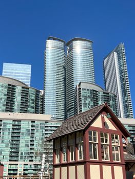 Modern skyscrapers of ICE Condominiums dominate the Toronto skyline under a clear blue sky.