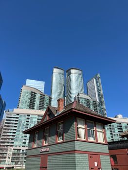 Toronto's skyline featuring modern skyscrapers and historic architecture under a clear blue sky.