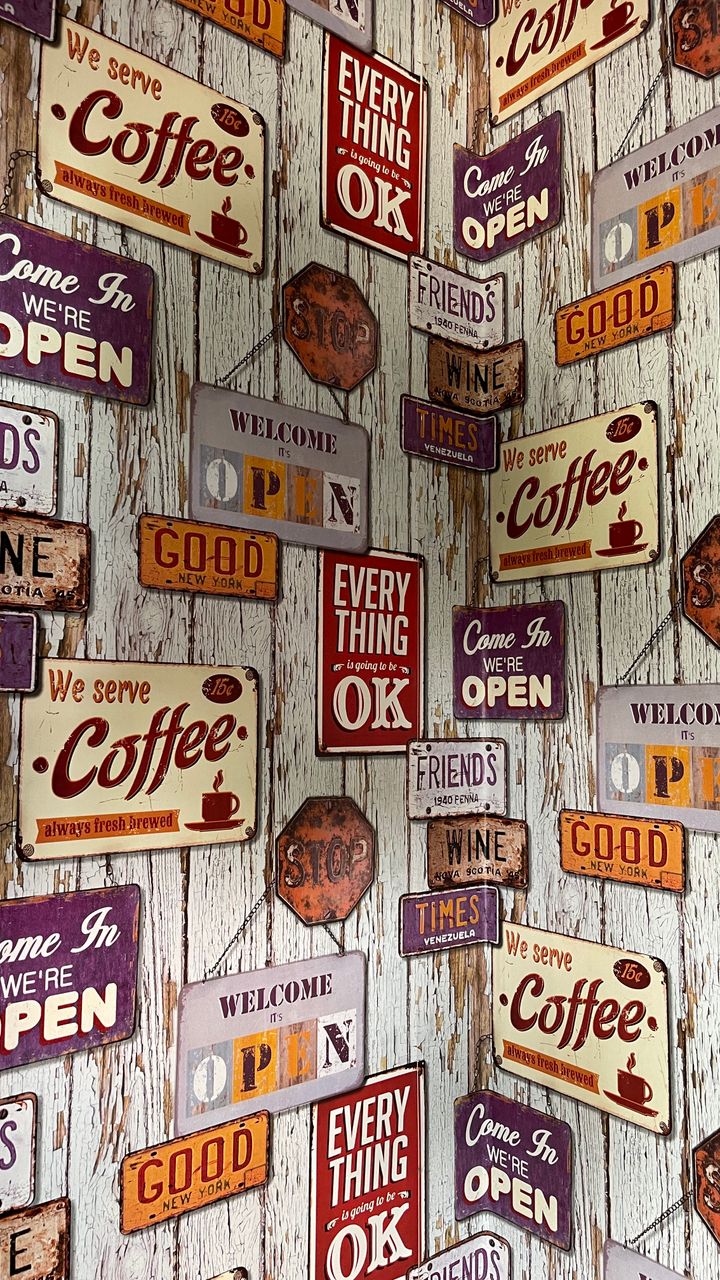 Nostalgic vintage tin sign hung above a dollar tree coffee bar design