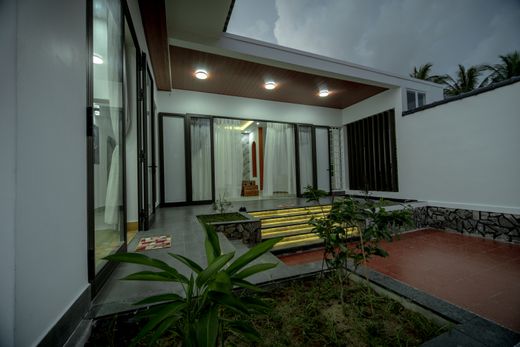 Courtyard house lit from within at evening — photo by Pew Nguyen on Pexels